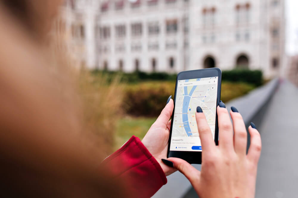 student using google maps on her smartphone