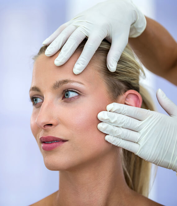 woman getting skin evaluation for botox injections