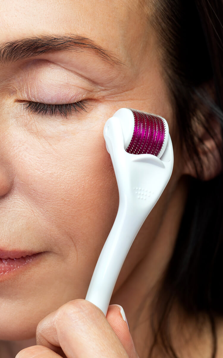 woman using anti-aging derma rolller treatment