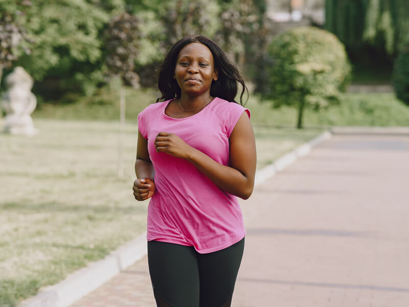 pretty black woman jogging to lose weight
