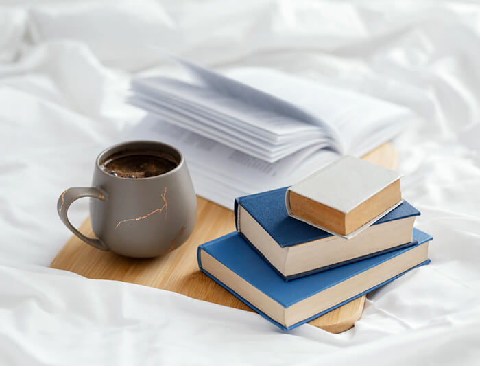 psychology books on the bed and a cup of coffee