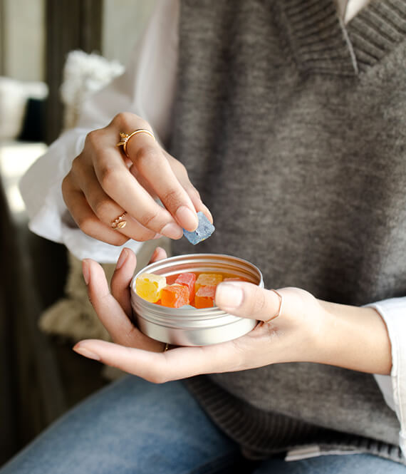 unrecognizable woman takes cbd gummies for insomnia