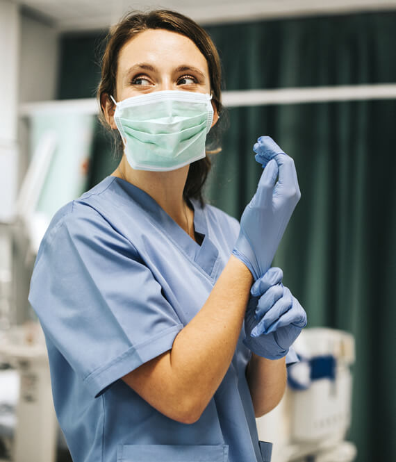 professional nurse practitioner smiling under protective medical mask