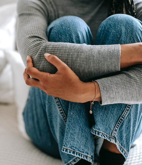 sad woman hugging her knees