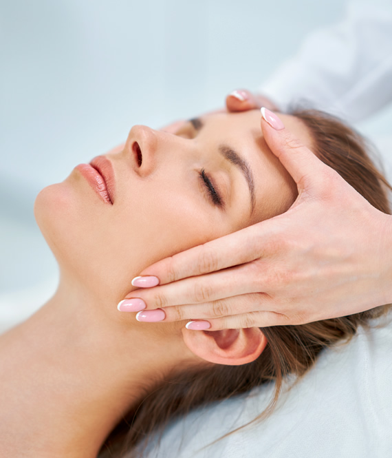aesthetician touching womans face