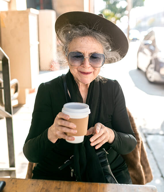 aging woman sipping coffee