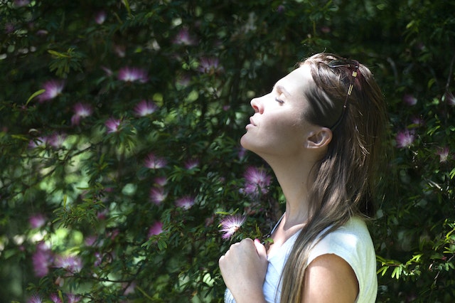 woman breathing mindfully in nature