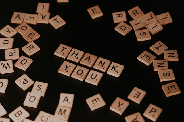 wooden letters spelling out thank you an a table