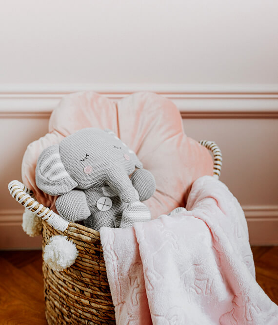 sensory toy in a basket of pillows