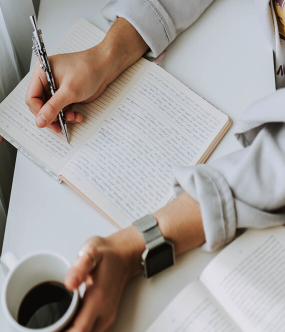 student writing in a notebook