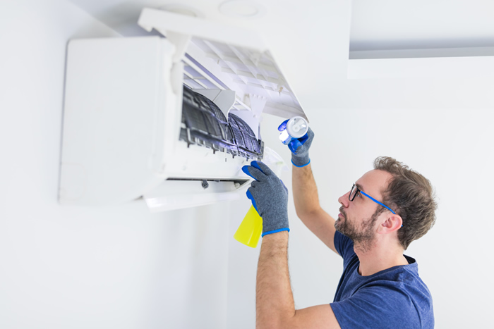 air conditioner expert cleans AC unit