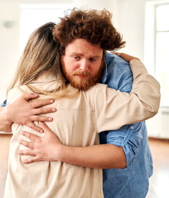 man hugging woman and is exhausted from being too empathetic