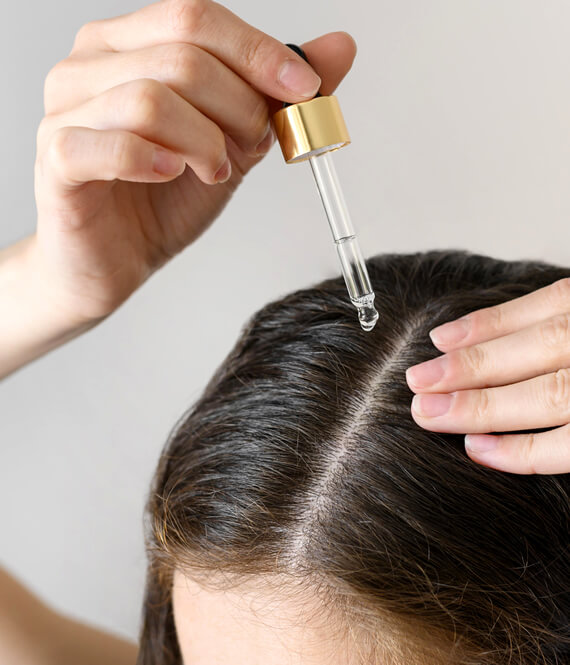 applying oil to scalp for hair care