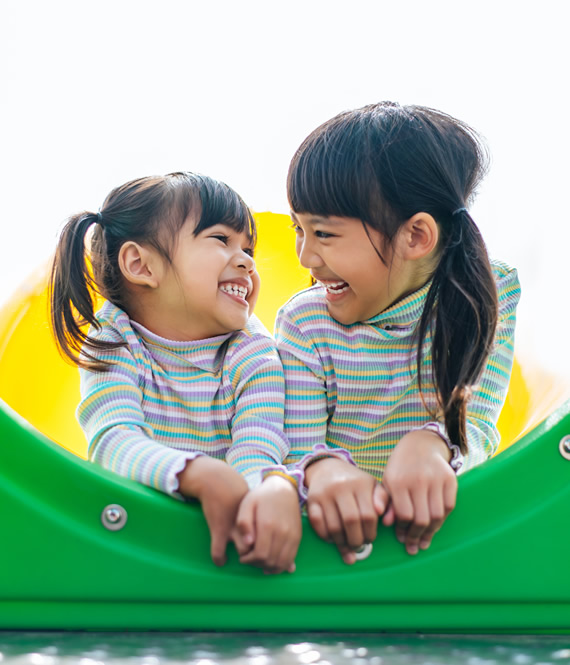 two girls happily playing