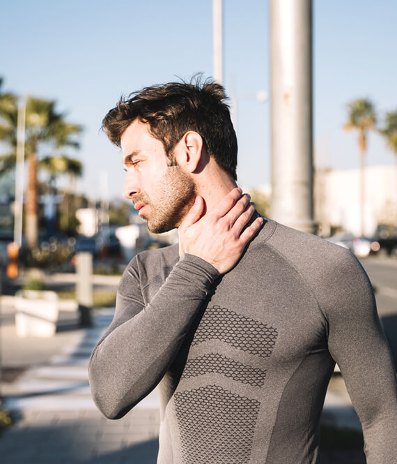 male athlete experiencing pain in his neck