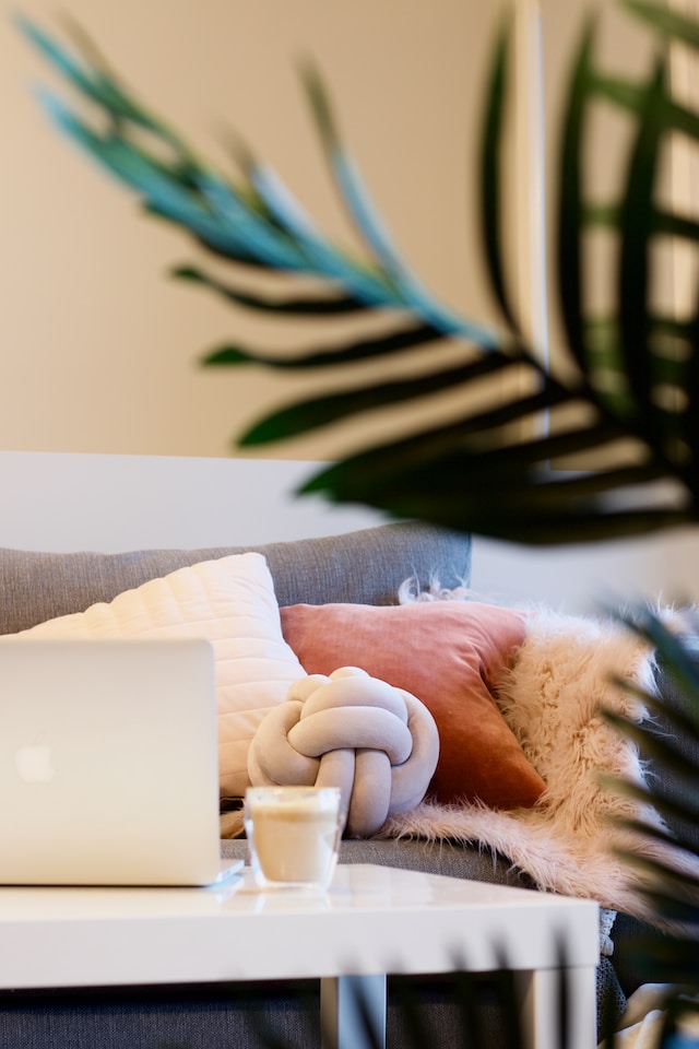 cozy pillows, blankets, cushions in a scandi style living room