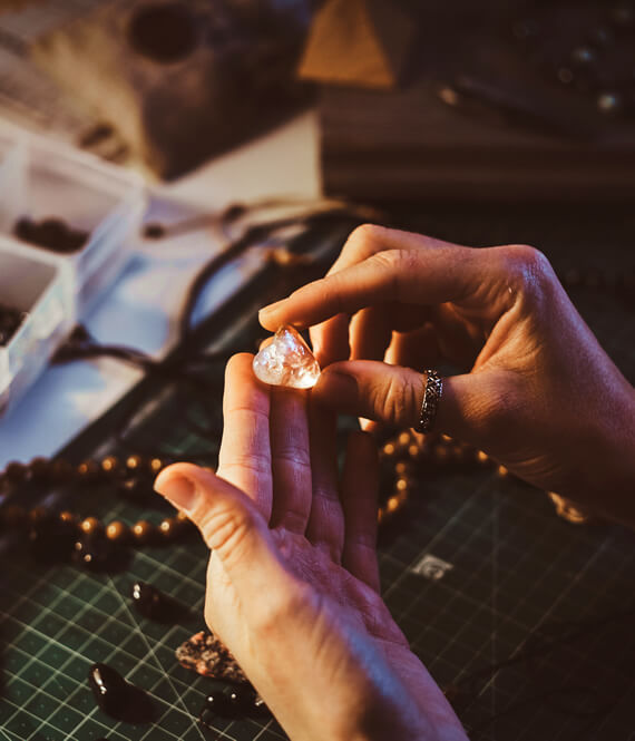 holistic wellness expert is holding a semi precious gem stone for gemstone healing