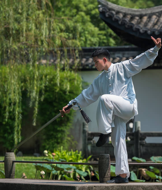 asian tai chi professional performing tai chi sword movements