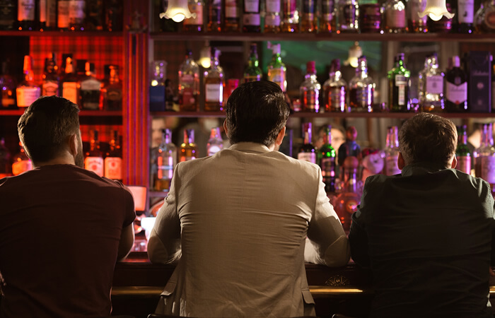men solo travellers talking to each other in a bar