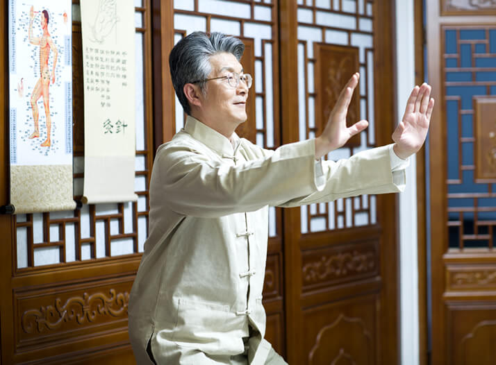 senior asian man practising tai chi in a temple