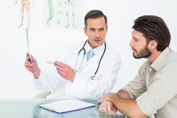 man consulting a doctor before getting a vasectomy