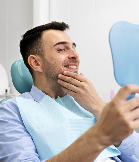 man enjoying his teeth after teeth hygiene procedure