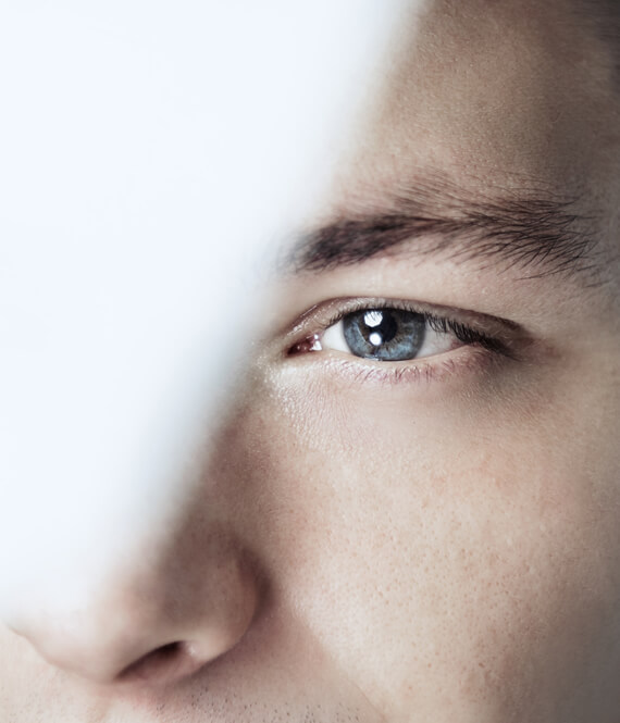 man protecting his eyes while in LASIK recovery