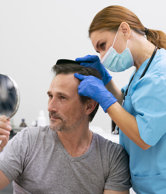 man with male pattern baldness getting treatment to combat hair loss