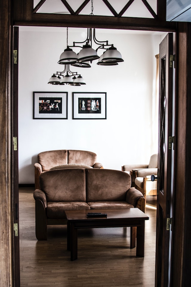 a brown sofa in a living room, surrounded by elegant interior design