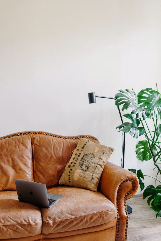 a brown sofa in a living room with leather upholstery