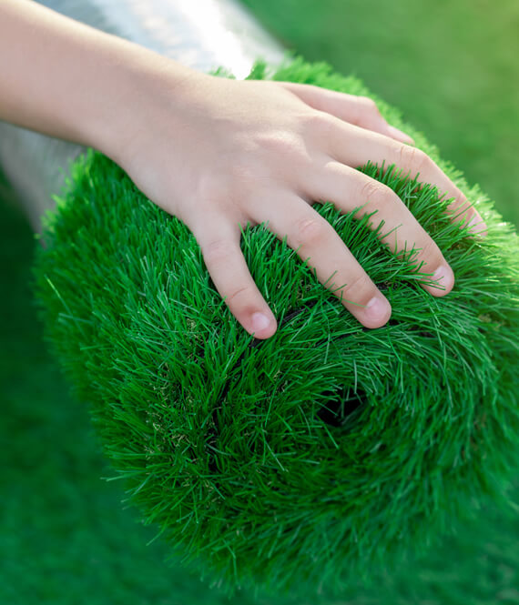 hand touching turf