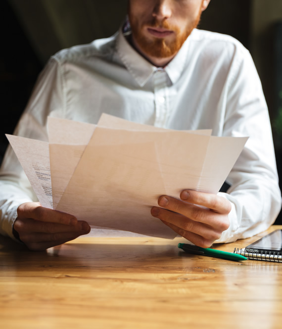 man reading dental insurance papers