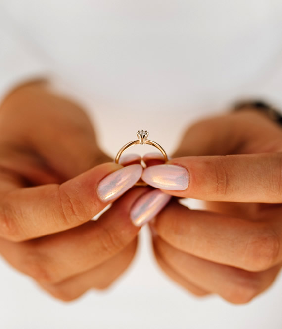 bride holding a ring created with lab-created diamonds