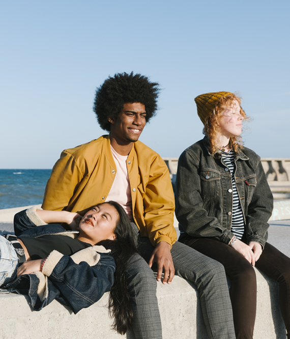 teenagers sitting near the beach