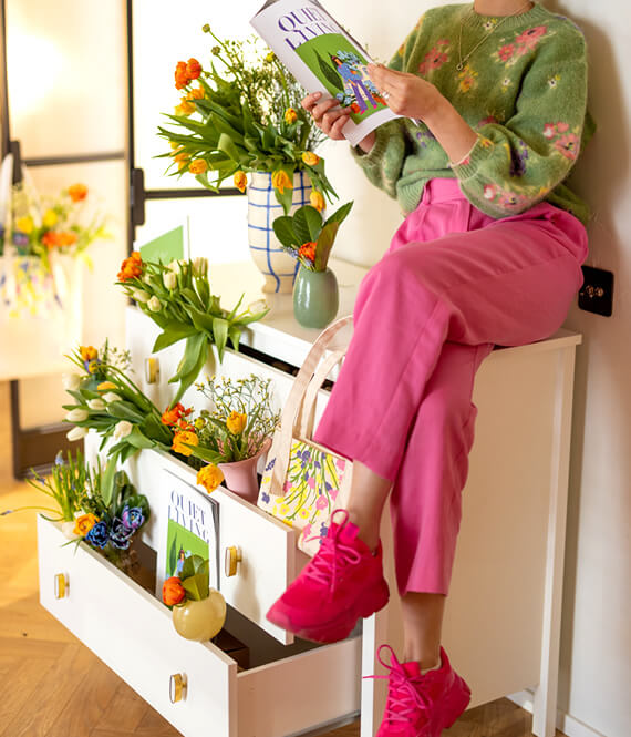 colorful spring interior with refurbished commode and plants