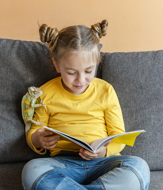 happy child reading educational books for kids