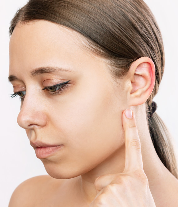 woman pointing at her ear