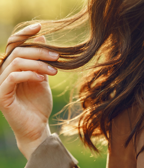 woman touching her damaged hair