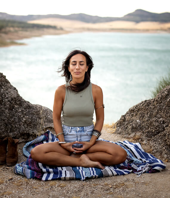 beautiful indigenous woman meditating to relieve stress