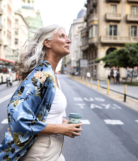 mature woman exploring neighborhood before buying property there