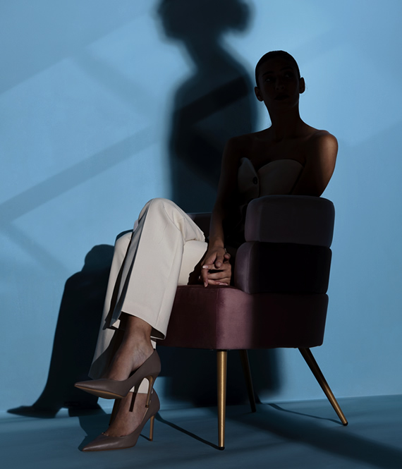 woman sitting in the shadows as a symbol of social isolation