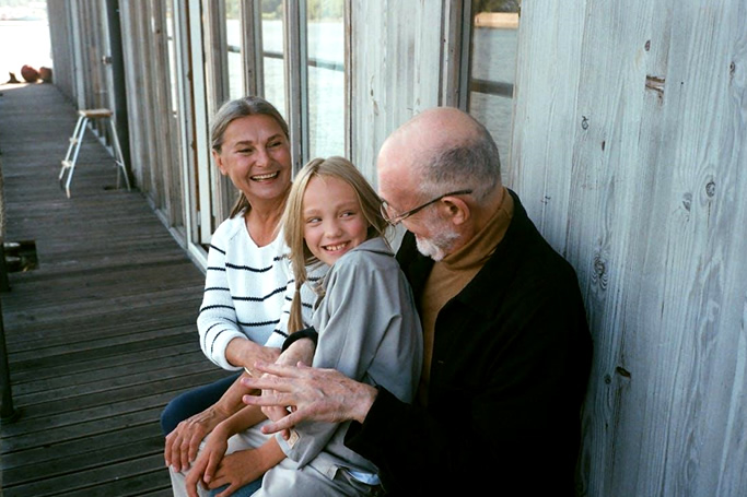 happy grandparents with their grandaughter