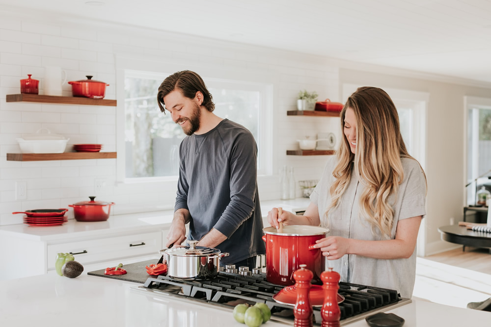 two people in a healthy marriage relationship cooking together