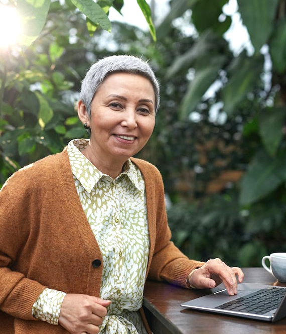 retired person working on her laptop as a side hustle