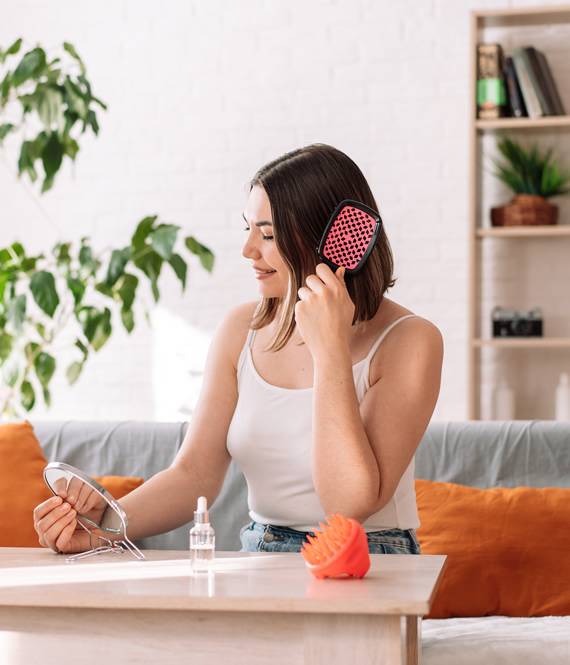 woman using a hair loss treatment at home