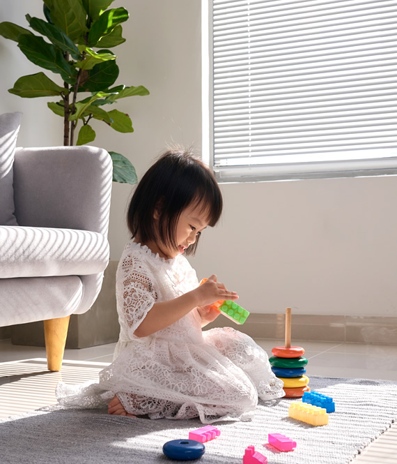 preschool girl plays with toys