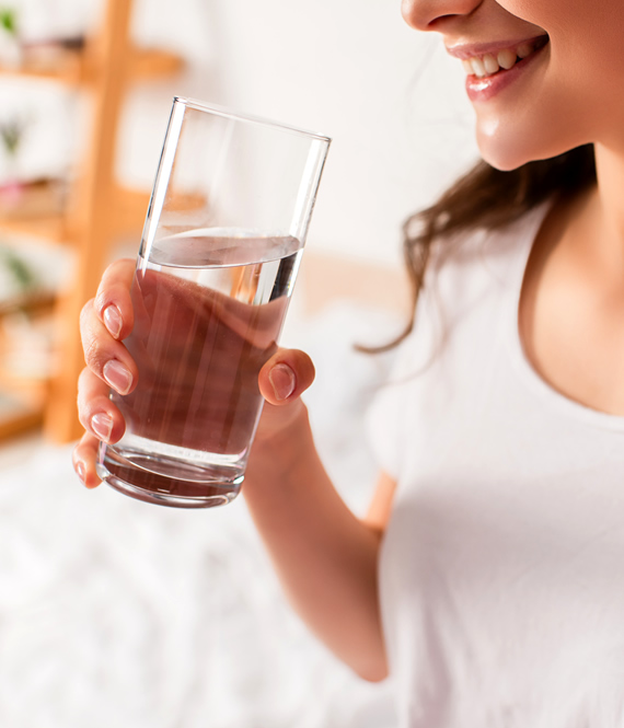 woman enjoys a glass of drinking water