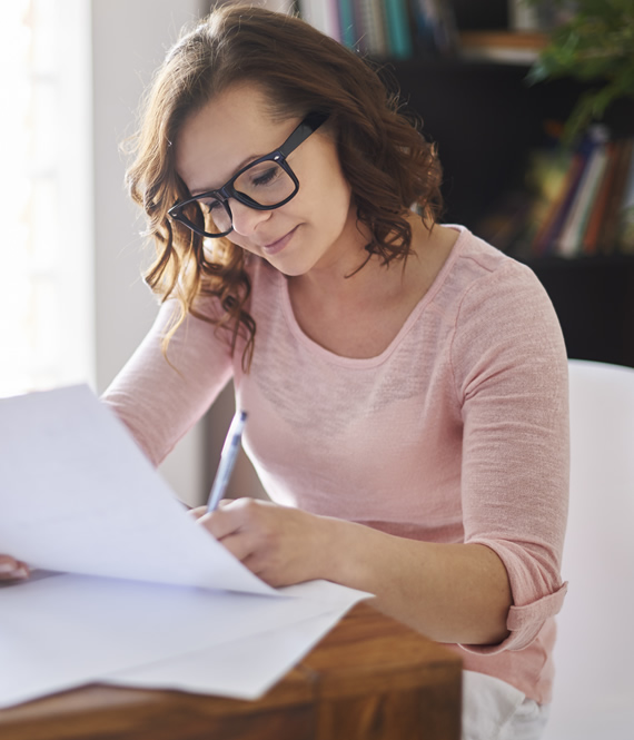 woman reads health insurance papers