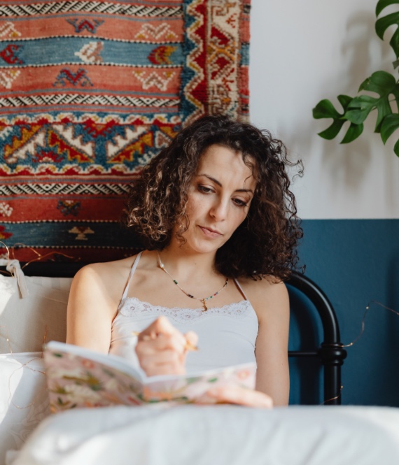 Person journals using morning journal prompts for anxiety