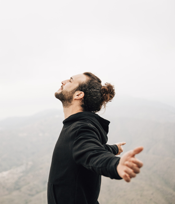 person in addiction recovery breathing clean air on a hike